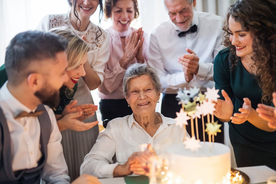 People celebrating elderly woman's birthday