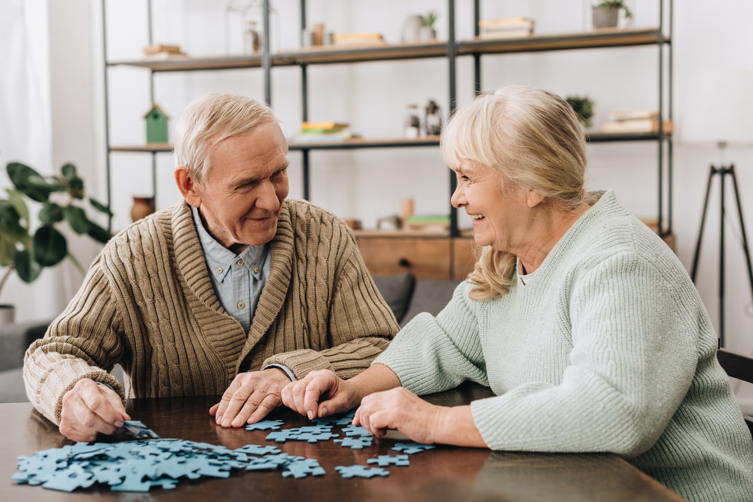 Elderly couple doing a puzzle 